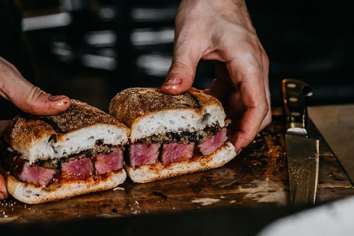 A sandwich from Firedoor, featuring its famous smoked meats.